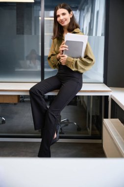 Ofisinde poz veren kadın moda tasarımcısı.