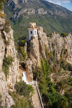 Old bell tower on the top of the rock, Guadalest in province of Alicante, Spain. Tourism, landscape, architecture concept clipart