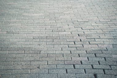 Close up view of walkway gray paving slabs material, selective focus.