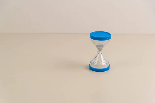 Blue hourglass on white background. Decoration artifact. Souvenir. Old time tracking equipment. Sand hourglass.