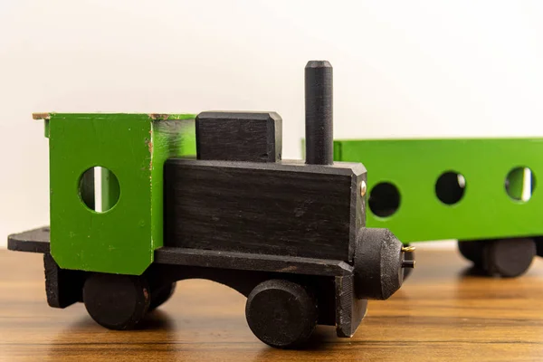Wooden craft toy train. Miniature toy. Wood and crafts. Miniature train and freight car. Miniature and souvenir.