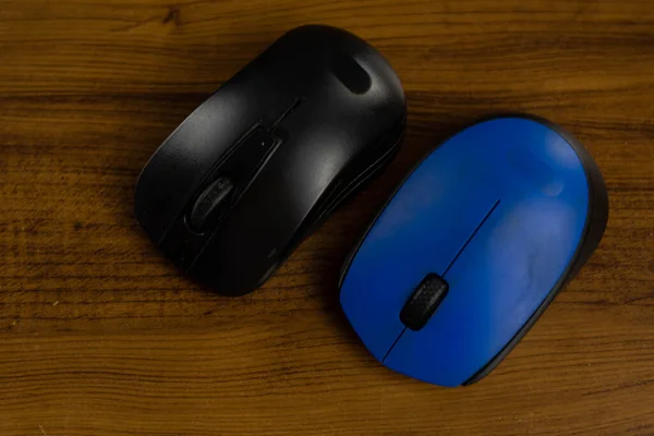 PC mouse on wooden background. Computer equipment. Desktop computer mouse. Accessory for electronic equipment.