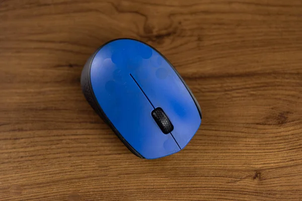 PC mouse on wooden background. Computer equipment. Desktop computer mouse. Accessory for electronic equipment.