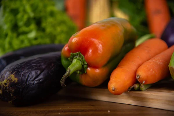 stock image Vegetables and greens for culinary use. Salad food. Miscellaneous ingredients on wooden background.