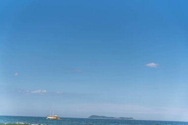 Tourist boat on the coast of Gamboa beach, Santa Catarina, Brazil.NEF. clipart