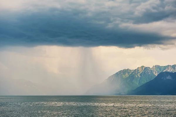 Beautiful landscape with rain over Alps and lake Geneva