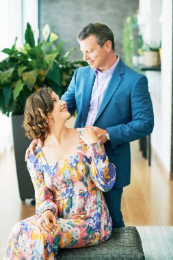 Indoor portrait of beautiful couple wearing formal clothes