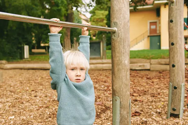 Stock image Outdoor portrait of adorable 4 - 5 year old little boy playing on playground