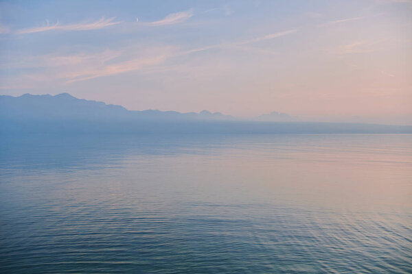 Nature background with calm blue hour lake at late evening 