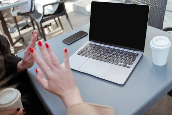 Woman at laptop. Picture of laptop on the table and female hands with red nails