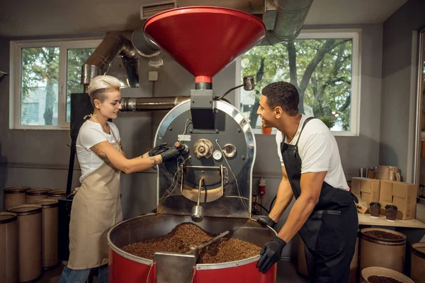 Smiling Young Roaster Her Pleased Male Colleague Checking Roast Degree — Stock Photo, Image