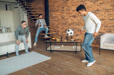 Arkadaşlarının önünde amatör bir futbol maçında oynayan iki genç sporcu.