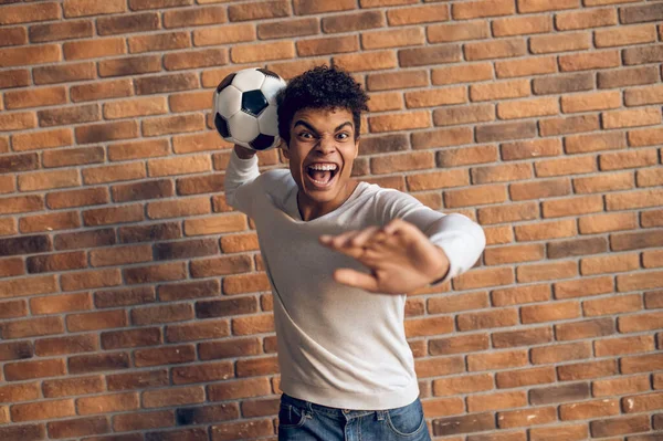 Aggressive Footballer Standing Brick Wall Throwing Soccer Ball One Hand — Stock Photo, Image