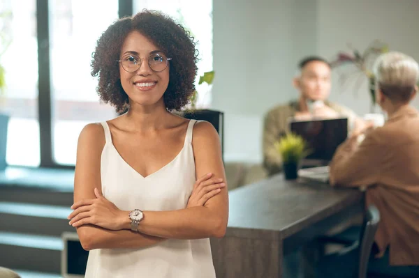 Glada Kvinnliga Företagare Glasögon Poserar För Kameran Med Medarbetare Sittande — Stockfoto