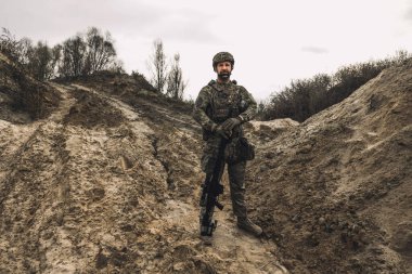 On a position. A soldier standing in a dig-position