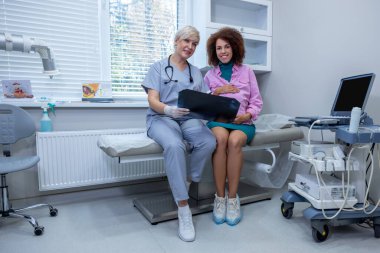 Third trimester. Pregnant woman having a consulttaion at the onbstetrician