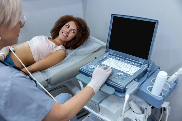 Ultrasonography. Gynecologist doing ultrasonography to a pregnant woman