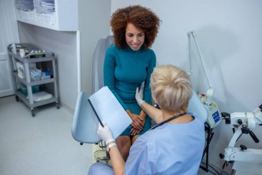 Womens issues. Curly-haired woman having an examination at the gynecologist office