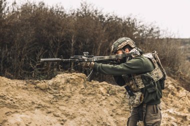 Shooting range. A soldier with a rifle on a shooting range