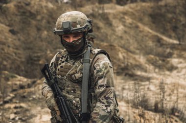 War zone. Man in military unifrom on a position