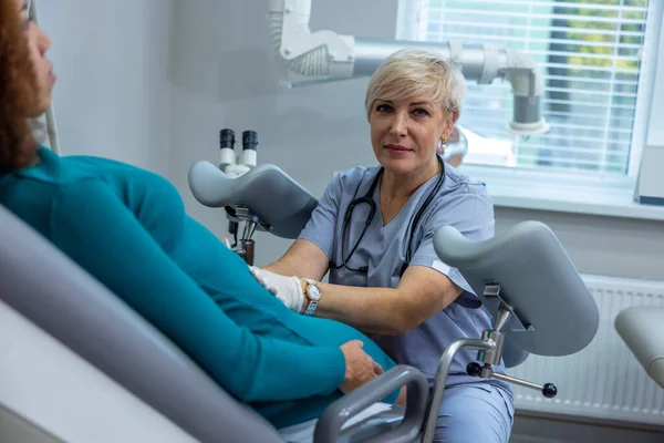 Womens issues. Curly-haired woman having an examination at the gynecologist office