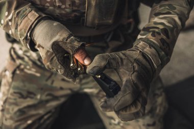 Fixing the weapon. Close up picture of a soldier with weapon