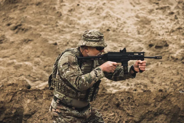 Shooting. Soldier with a rifle on a shooting range