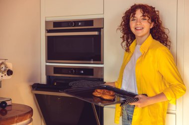 Baking. Cute girl baking buns in the kitchen