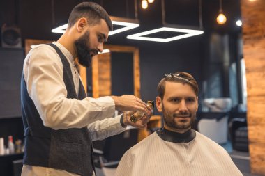 Shaving. Barber trimming shaving cleints neck with electric razor