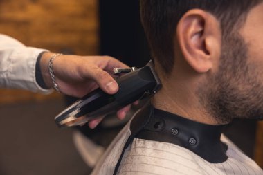 Shaving. Barber trimming shaving cleints neck with electric razor
