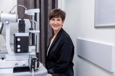 Eyesight check up. Short-haired mid aged woman having an eyesight check