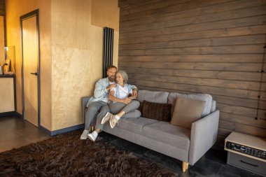 Time at home. Mature couple peacefully spending time at home together