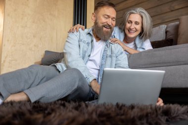 On internet. Man and woman watching something online together