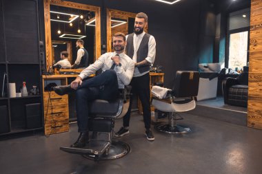 At the barbers. Elegant client sitting in a chiar in the barbershop