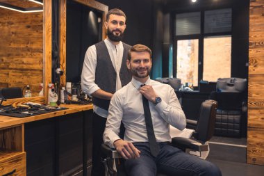 At the barbers. Elegant client sitting in a chiar in the barbershop