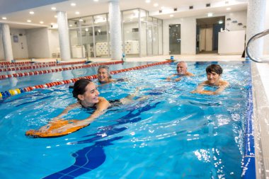 Swimmers. Group of people swimming together in the swimming pool