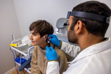 Hearing checkup. Senior woman having hearing check up at ent doctor