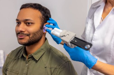 ENT doctor. ENT doctor examining the patient with the medical apparatus