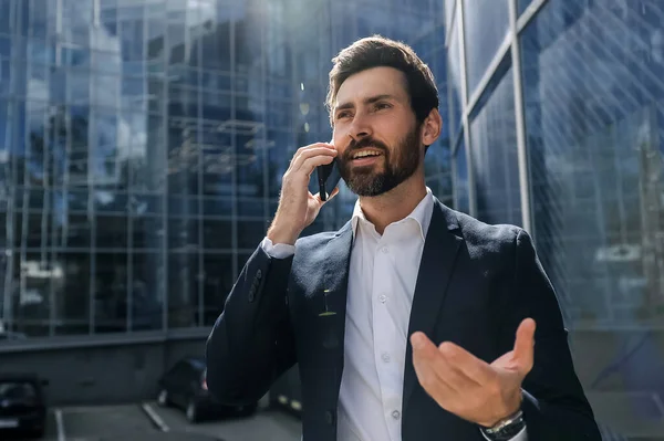 Business call. Bearded young manager having a business call