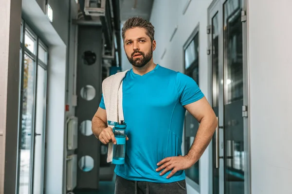 stock image After workout. Young handsome bearded sportsman with a bottle of water