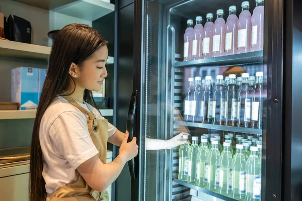 Young Asian Cafe Worker Taking Bottle Shelf Refrigerated Display Cabinet — Stock Photo, Image