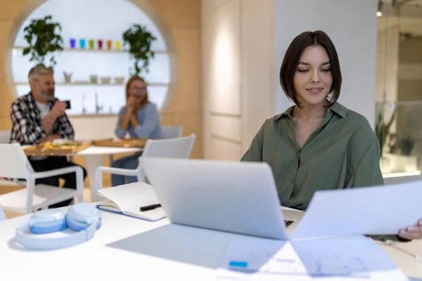 Smiling Corporate Worker Sitting Portable Computer While Looking Document Her — Stock Photo, Image