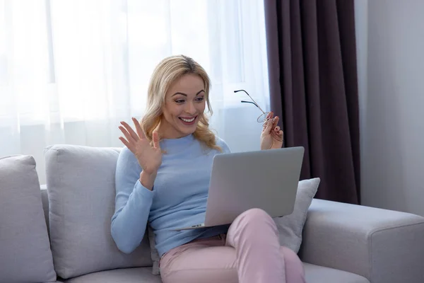 Smiling Happy Female Sitting Cozy Sofa Waving Someone Video Chat — Stok Foto
