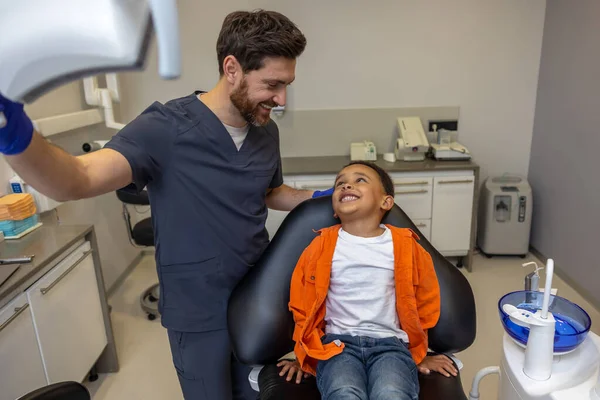 Diş Hekimliğinde Doktor Koyu Tenli Çocuğa Tıbbi Aletler Gösteriyor — Stok fotoğraf
