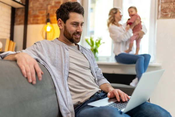 Father Working Laptop Mother Daughter Background Playing Home Interior — Stock Photo, Image