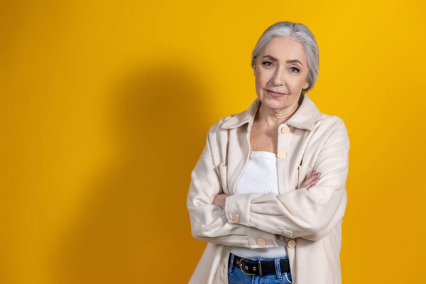 Woman. Good-looking woman in beige standing on yellow background