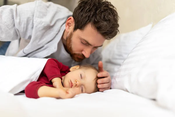 Handsome Brunette Father Kissing Sleeping Infant Baby Tenderly Home Interior — Stock Photo, Image