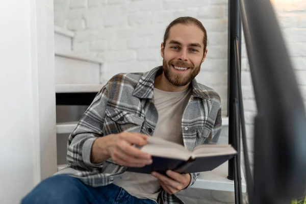 Attractive Young Man Reading Book While Sitting Stairs Home Enjoying — Stock Photo, Image