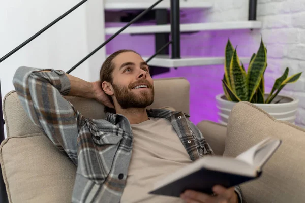 Handsome Smiling Happy Young Man Reading Book Dreaming While Sitting — Stock Photo, Image