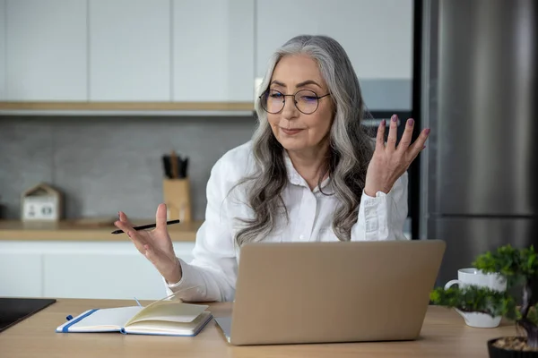 stock image Video call. Elegant business woman having a video call and looking involved